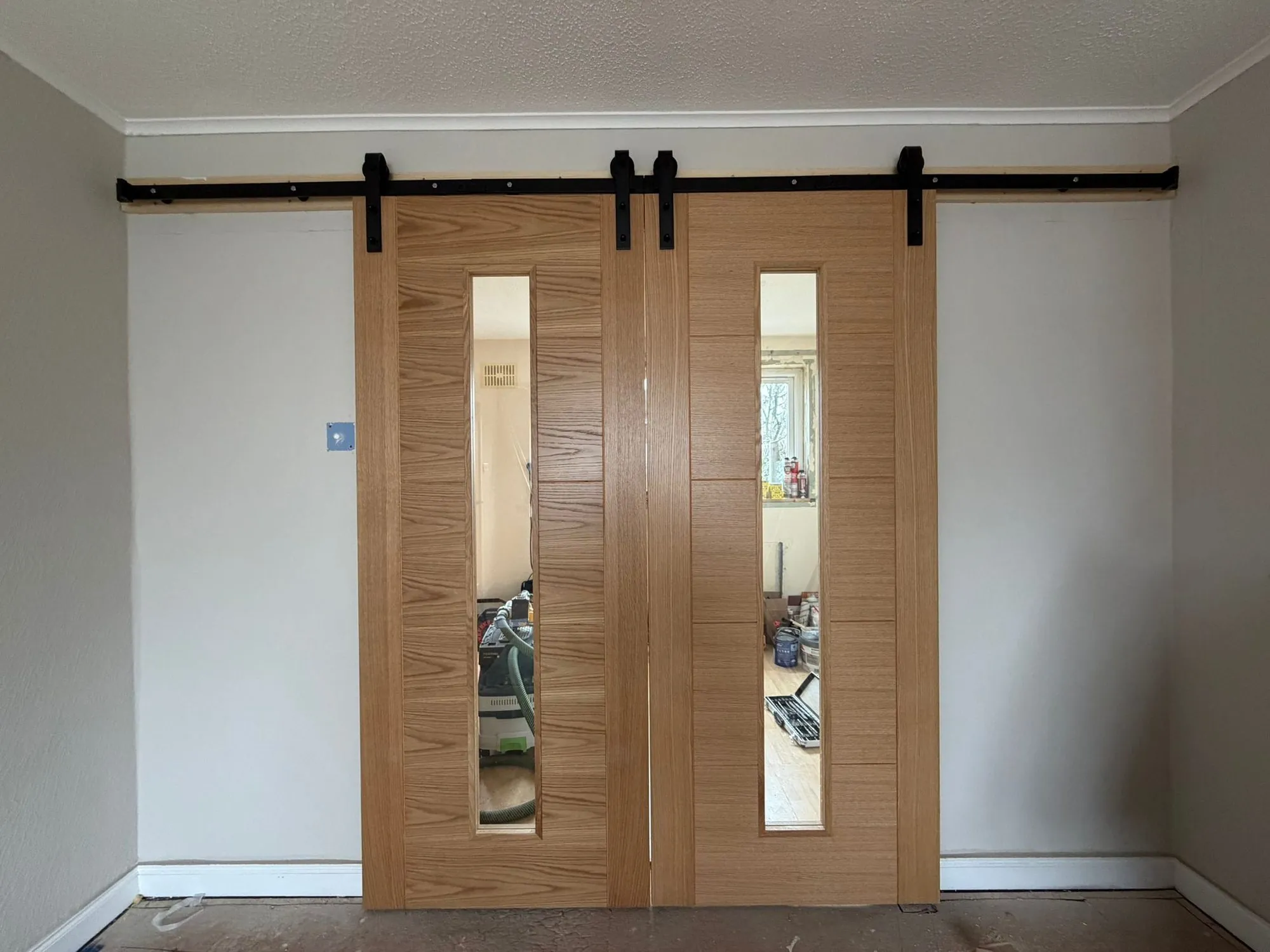 Oak barn-style sliding doors and architectural joinery