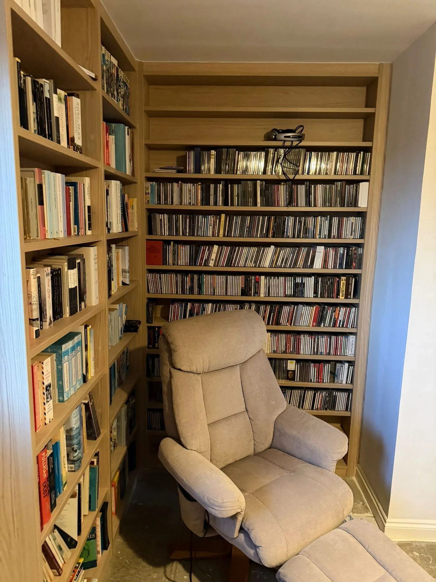 Bespoke floor-to-ceiling bookcase with built-in window seat by Oli's Joinery