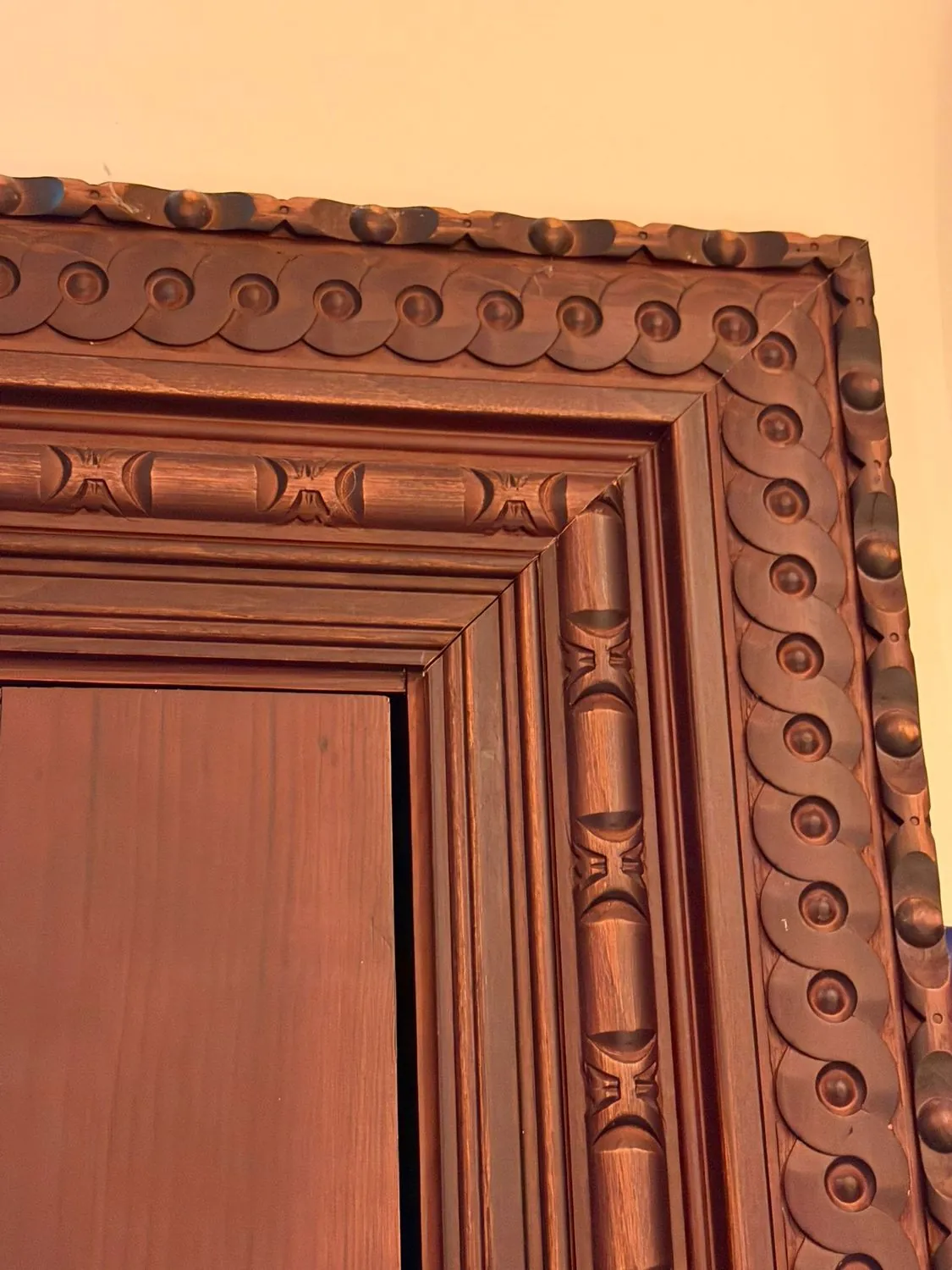 Restored ornate carved timber frame