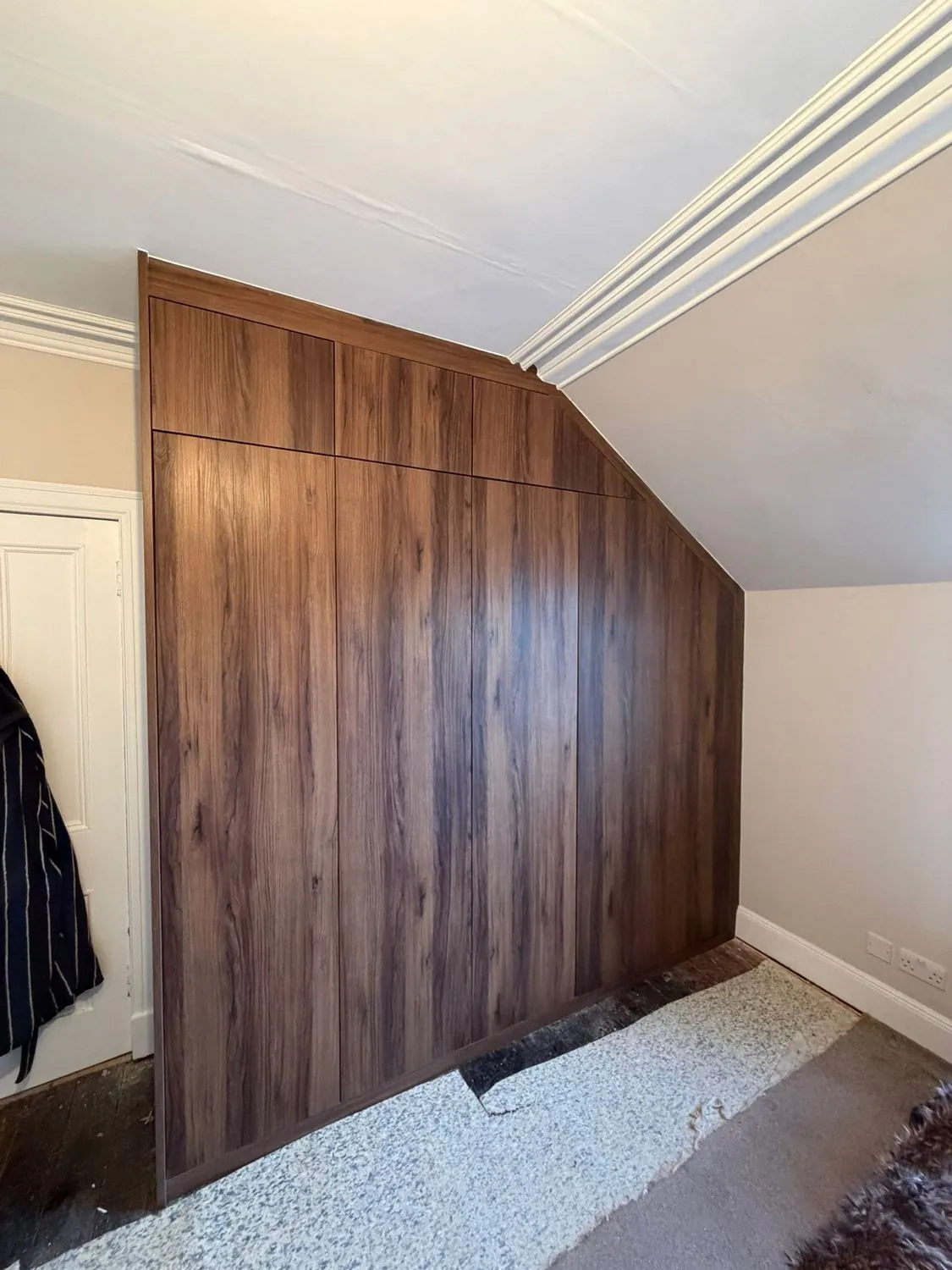 Walnut fitted wardrobes in a loft bedroom
